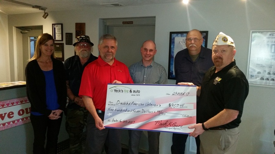 Mark presenting the $907.44 check